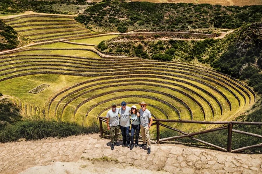 Grupo de viajeros frente a los andenes circulares de Moray en Cusco