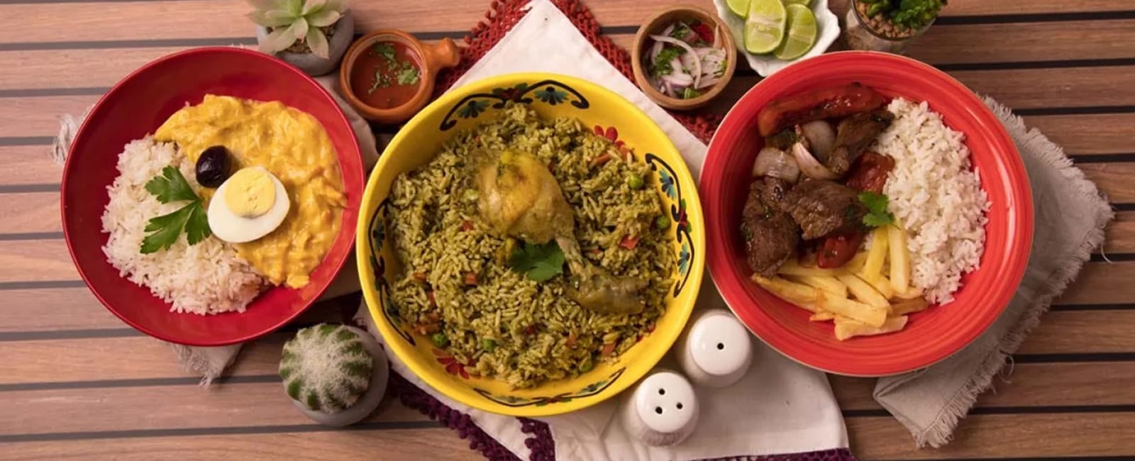 Vista cenital de varios platos de gastronomía peruana servidos sobre una mesa