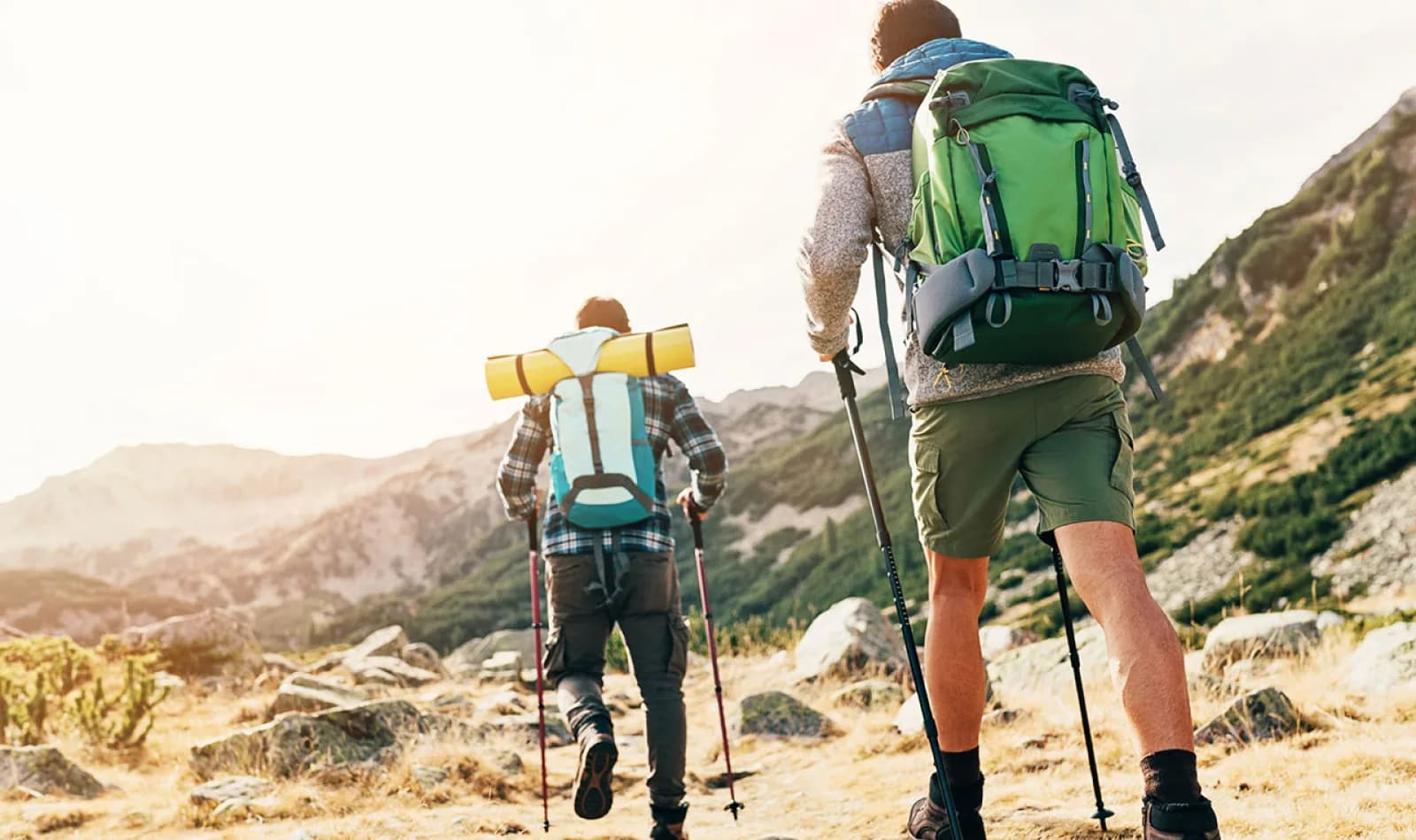 Viajeros haciendo senderismo con bastones de trekking.